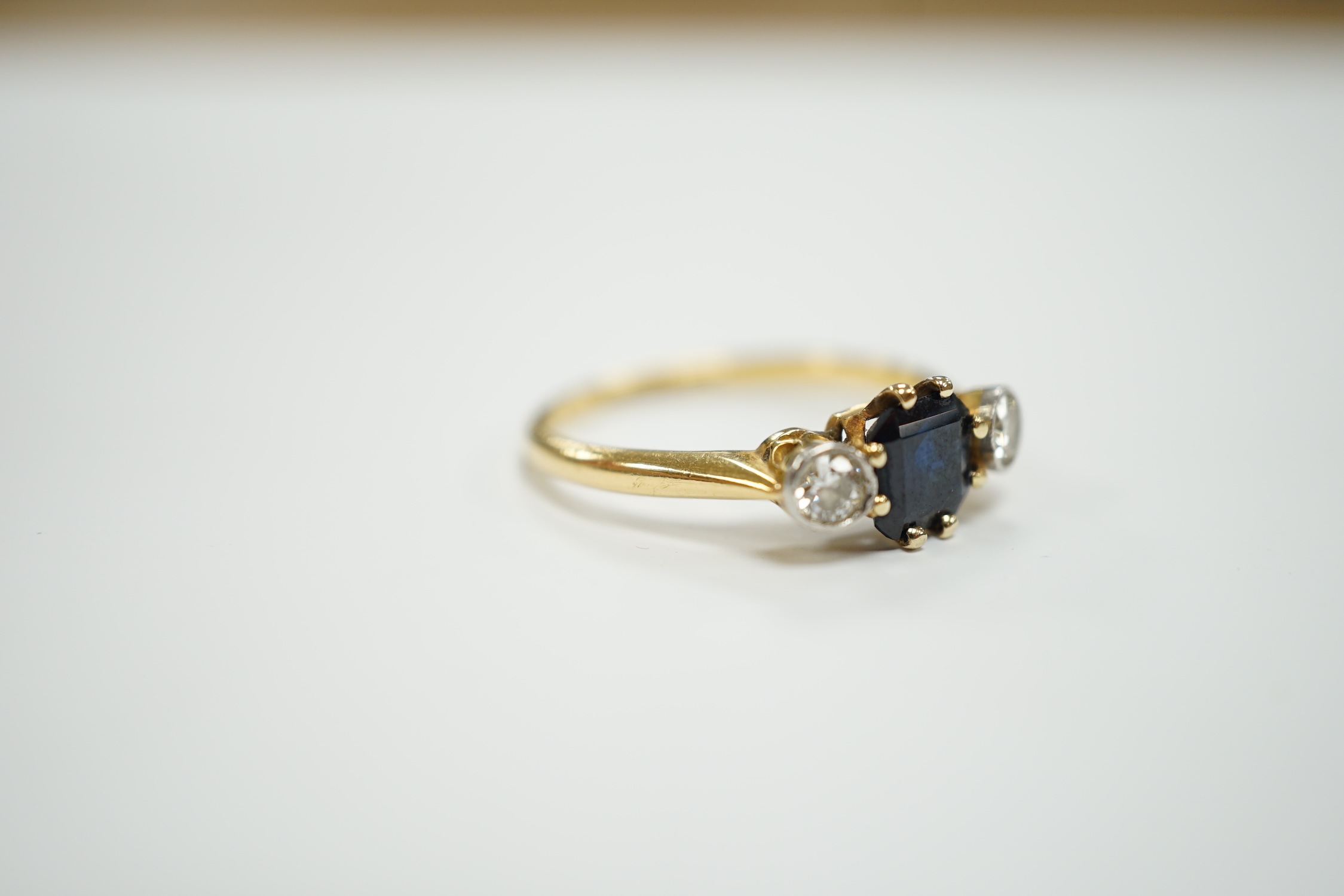 An 18ct and plat, single stone sapphire and two stone diamond set ring, size O/P, gross weight 3.1 grams.
